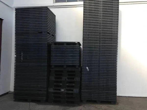 New and used plastic pallets stacked at Pallet Recycling Guys Surrey BC yard